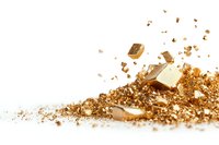 Scattered golden metallic fragments and dust on white background, creating luxurious composition with dynamic movement and rich texture. Isolated design element.