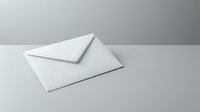 White envelope on gray surface for business correspondence and mailing needs.