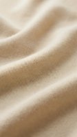 Soft beige cotton fabric with gentle folds and natural texture, ideal for apparel, textile, and fashion design projects.