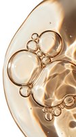 Macro shot of golden liquid bubbles and oil droplets on translucent surface with warm light reflections, isolated on white background for skincare and cosmetic product design use.