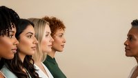 Diverse group of professional women in business attire standing in profile, representing teamwork, leadership and workplace diversity in modern corporate environment.