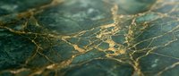 Luxurious dark green marble surface with elegant gold veining patterns creating sophisticated natural stone texture for premium interior design applications.