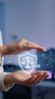 Businessman hands protecting legal risk indicator shield with scales of justice symbol representing compliance and regulatory protection in corporate environment.