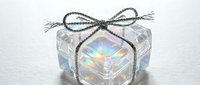 Transparent crystal gift box with iridescent rainbow reflections and rope bow isolated on white background for holiday design and decoration projects.