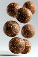 Homemade energy balls with nuts and seeds on white background. Healthy protein snacks for fitness diet and clean eating lifestyle.