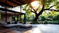 Modern luxury patio with gray outdoor furniture on wooden deck, surrounded by lush garden landscape and large tree with sunlight filtering through branches.