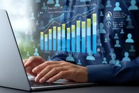 Businessman analyzing financial data on laptop with holographic charts and graphs showing business growth metrics and performance indicators.