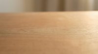 Close-up of light wood surface with natural grain texture and warm finish, suitable for backgrounds, interior design projects, and furniture photography.