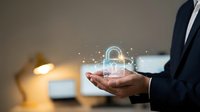 Business professional holding glowing digital padlock with network connections representing cybersecurity, data protection and secure technology solutions.
