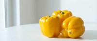 Yellow bell peppers isolated on white background, fresh produce for cooking, healthy food ingredient, culinary use.