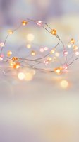 Warm glowing fairy lights with soft bokeh creating magical ambiance for holiday celebrations and cozy home decor on dreamy blurred background.