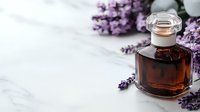 Vintage glass bottle with aromatic oil and fresh lavender flowers on white marble background, wellness and aromatherapy concept for spa treatments.