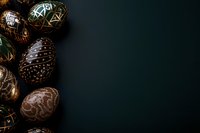 Decorated Easter eggs with intricate patterns and metallic details arranged on dark background with copy space for seasonal holiday designs.