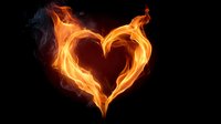 Burning heart shape made of bright orange and yellow flames against black background for romantic and passionate design concepts.