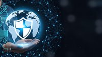 Businessman holding glowing globe with security shield icon surrounded by digital network connections representing global cybersecurity protection.