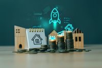 Real estate investment growth concept with wooden house models, stacked coins, and digital rocket hologram representing property market success and financial planning.