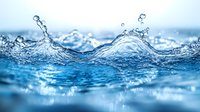 Dynamic water splash with crystal clear waves creating peaks and curves against light blue background, macro photography showing intricate liquid motion and droplets.
