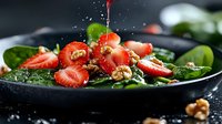 Water splashing over fresh red strawberries and green leaves on a black plate, ideal for food and beverage marketing, healthy eating, and culinary content.