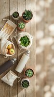 Eco-friendly lifestyle flat lay with succulents, reusable bags, bamboo utensils and glass bottle on wooden background for sustainable living concepts.
