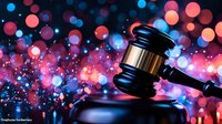 Wooden judge gavel on black reflective surface against blurred pink and blue bokeh lights background, dramatic legal concept for justice and law.