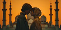 Romantic Middle Eastern couple sharing intimate moment at sunset with mosque silhouettes in background, perfect for wedding and travel content.