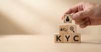 Hand placing wooden blocks spelling KYC with compliance icons for know your customer verification and identity authentication processes.