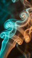 Abstract colorful smoke swirls in turquoise and orange hues creating flowing patterns against dark background for creative design projects.