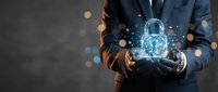 Businessman in dark suit holding glowing digital padlock with sparkling light effects, representing cybersecurity, data protection, and secure technology solutions for business.