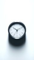 Modern black wall clock with minimalist white dial and metal hands displaying time management, punctuality, and scheduling concepts for business and productivity applications.