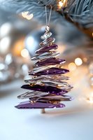 Modern spiral Christmas tree ornament in purple and silver with soft bokeh lights background, elegant holiday decoration for festive winter season.