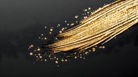 Golden glowing brush stroke with sparkling particles and splatter effect on dark background, luxury cosmetic makeup promotional design element.