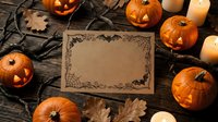 Halloween greeting card mockup with carved pumpkins, candles and autumn leaves on rustic wooden background for seasonal party invitations.