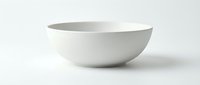 White ceramic bowl isolated on white background, minimalist tableware for kitchen and dining concepts, clean matte finish porcelain dishware.