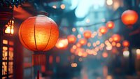 Traditional red paper lanterns glowing warmly at dusk with soft bokeh lights creating magical festive atmosphere during Asian celebration event.