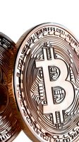 Macro view of cryptocurrency coin showing detailed Bitcoin symbol and texture pattern in copper metallic finish. For finance and digital currency concepts.