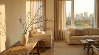 Modern minimalist living room with warm sunlight streaming through large windows showcasing city skyline view and natural decor elements.