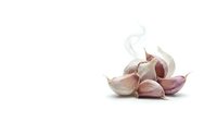Isolated garlic cloves with papery skin and steam wisps on white background, ready for culinary, cooking, and food design projects.