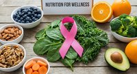 Healthy nutrition concept with pink ribbon, fresh vegetables, fruits and nuts on wooden background promoting cancer awareness and wellness lifestyle.