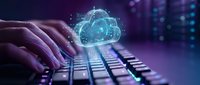 Hands typing on laptop keyboard with glowing cloud computing hologram icon, representing digital transformation and data storage technology solutions.
