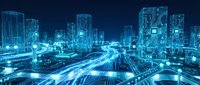 Smart city infrastructure with illuminated buildings and glowing traffic networks at night, representing urban connectivity, digital transformation, and IoT technology.