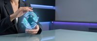 Businesswoman holding glowing digital globe hologram, representing global connectivity, international business, and technology innovation for corporate communications.