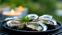 Fresh oysters on black plate garnished with herbs and microgreens, served with candlelit ambiance in background, luxury seafood dining presentation.