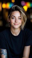 Young blonde woman with short bob haircut and tattoo smiling warmly in casual black t-shirt against colorful bokeh lights background for lifestyle content.