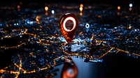 Glowing red location pin marker floating above night city aerial view with illuminated streets and buildings, navigation concept for maps and GPS systems.