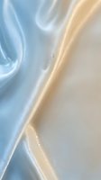 Soft flowing waves of blue and cream silk fabric with luminous highlights and delicate folds, creating an elegant abstract composition suitable for luxury branding and textile design projects.