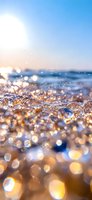 Sparkling ocean waves catch golden sunlight creating magical bokeh effect on water surface, macro close-up view of sea foam and droplets at sunset or sunrise.