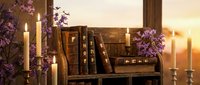 Vintage books arranged on wooden shelf with burning candles and purple flowers creating warm cozy reading atmosphere for home decor and literary themes.