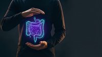 Man protecting glowing digestive system hologram with hands showing gut health care and medical protection concept for healthcare presentations.