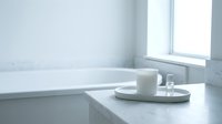 Minimalist bathroom counter with white mug, soap dispenser, and glass on marble surface near bathtub and window for spa, wellness, and home decor design projects.