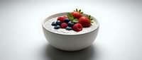 Fresh mixed berries on creamy yogurt in white bowl, healthy breakfast with strawberries, blueberries and raspberries for nutritious morning meal preparation.